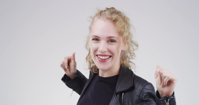 Happy, funny and dancing woman with a smile listening to music against a gray studio background mockup. Radio, party or dance disco lady or audio dancer having fun snapping fingers or hands mock up.