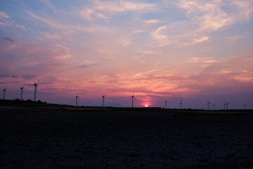Wind turbines at the sunset in the wind farm in Zaragoza, Spain. Alternative energy sources.