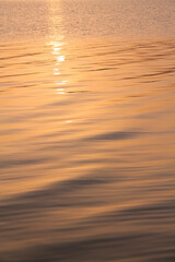 Marine background with water rippled surface. Sunrise.