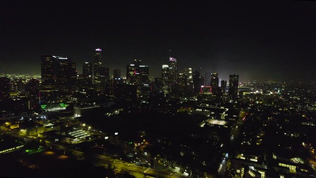 An Aerial Parallax of the Downtown LA Skyline during the 4th of July, with fireworks going off in the air.