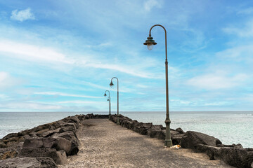 Pier with lanterns in Costa Teguise in Lanzarote, Canary Island, Spain