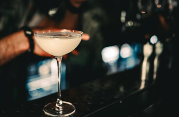 man hand bartender making cocktail in glass on the bar counter