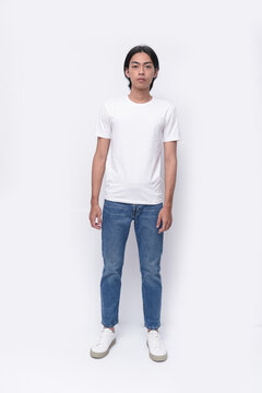 Full body portrait of a young man in a white t-shirt. jeans , casual fashion.