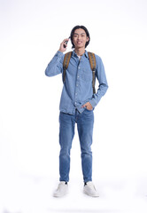 Full portrait casual  young man wearing jeans shirt, jeans using cellphone, with backpack isolated over white background.