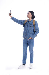 Full portrait casual  young man wearing jeans shirt, jeans with backpack with using cellphone  isolated over white background.