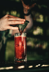 bartender making cocktail Bloody Mary in a nightclub bar