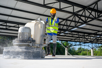 Construction workers use concrete floor polishers or polishers to smooth surfaces and decorate...