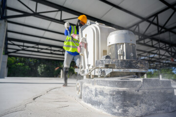 Close-up shot of concrete floor polishers Construction workers use concrete floor grinders or...