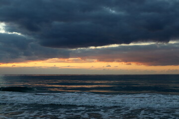 Naklejka na ściany i meble The sun sets below the horizon on the Mediterranean Sea in northern Israel.