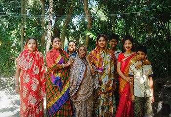 Fototapeta na wymiar A group photo of Bangladeshi combined family consists of many generations, hindu religious people in traditional costumes