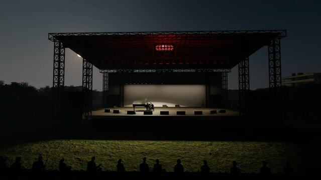 A pianist on an outdoor stage at nighttime, 4K