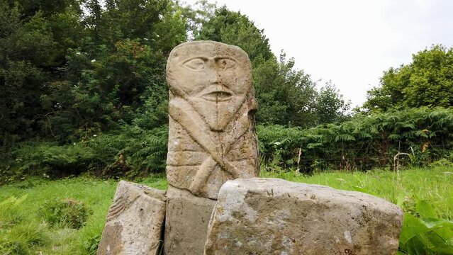 This is a bronze age stone carviing with two faces,called Janus, located In Caldragh Cemetery on Boa Island, Lower Lough Erne. Northern Ireland