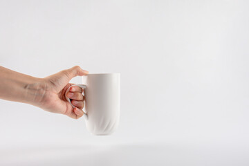 hand and white cup isolated on white background