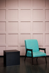 Blue chair over pink wall in the hipster interior modern room.