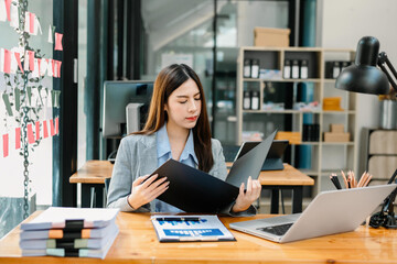 Fototapeta premium portrait of female office businesswoman startup daydreaming about her work, startup and working with laptop on office desk in office room sitting at coffee shop.