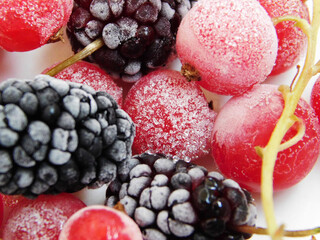 Frozen red currant and mulberry macro photo.