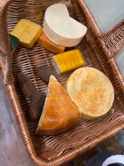 Fototapeta na wymiar A collection of different types of cheese in a basket. Different Types Of Delicious Cheese. Dairy Products