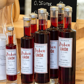 KREMS, AUSTRIA - JULY 13, 2019:  Bottles of Pine Liqueur (Zirben Likor) at a market stall in the Old Town