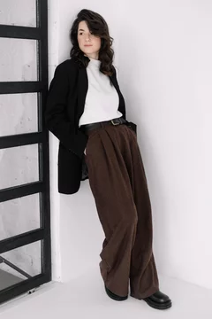 Attractive woman wear business look. Brunette model wear white shirt, black  men's jacket and brown baggy pants. Winter, fall autumn or spring minimal  outfit. Photos