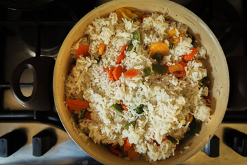 A pot with pilaf in the kitchen, a view from the top