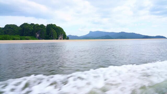 Krabi Island in Thailand.
pov. on a boat sailing in the middle of the sea among beautiful nature and green mountains on an island in the middle of the sea.4k