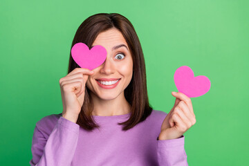 Closeup photo of adorable funky young lady dressed purple t-shirt pink heart cover eye isolated green color background