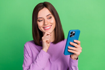 Photo of curious interested lady blogger read gadget multimedia share news isolated green color...