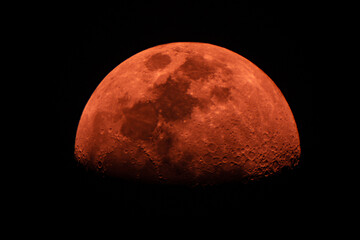 closeup of red moon from telescope