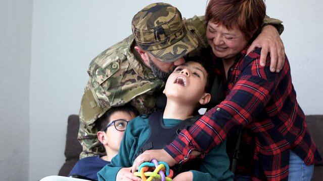 Military soldier being welcomed home by his family	