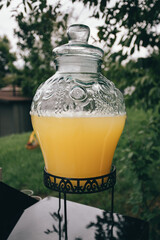 party details. big glass jar with lemonade in the yard. High quality photo