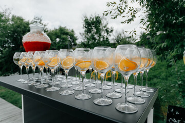 outdoor bar. empty glasses and big jar with refreshment drink. High quality photo
