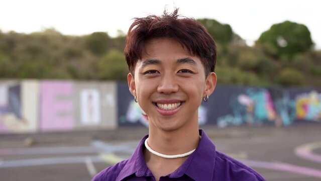 Young Asian Man With Make Up Smiling On Camera	