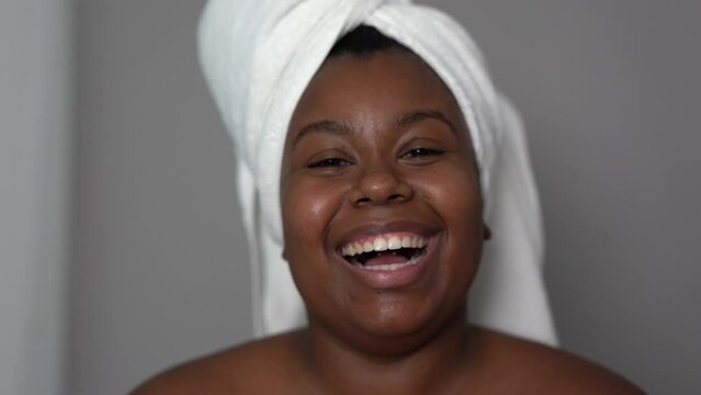 Young curvy african woman smiling on camera during spa day - Beauty treatment concept
