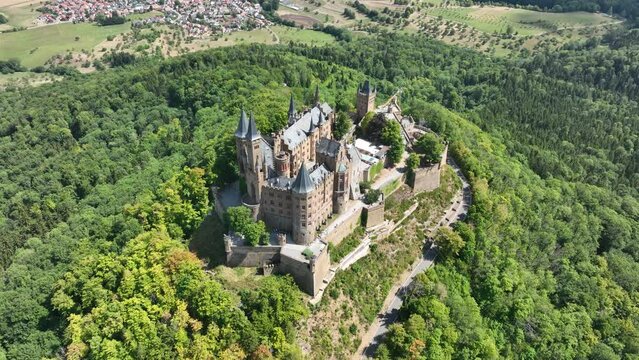 Burg Hohenzollern castle between Hechingen and Bisingen Germany, was the medieval castle of the Hohenzollern family. Stronghold fortress culturale heritage. Aerial drone overhead view in summer.