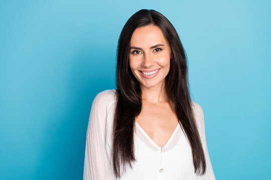 Photo of cheerful adorable young lady wear white top smiling isolated blue color background