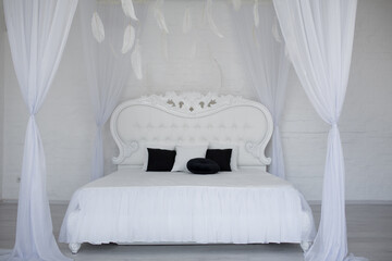 Cozy bedroom area at luxury studio apartment with a free layout and big panoramic window.