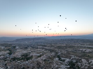 Aerial cinematic drone view of colorful hot air balloon flying over Cappadocia