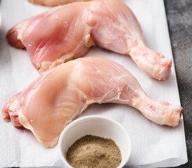 Skinless Raw chicken legs on white paper. Raw chicken legs for barbecue or soup. Fresh raw chicken legs.