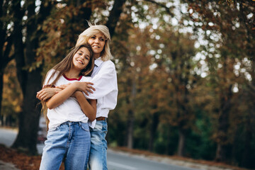 Fototapeta premium Mother with daughter together in autumn park