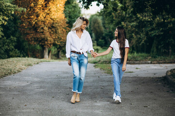Fototapeta premium Mother with daughter together in autumn park