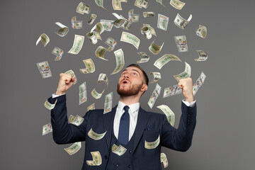 Happy business man very rich guy with money dollar bills in air like rain. Business success concept