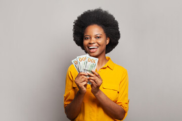 Happy black businesswoman having fun holding American dolar money on white, success in business...