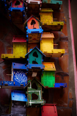 Many colorful birdhouses sticked together. 