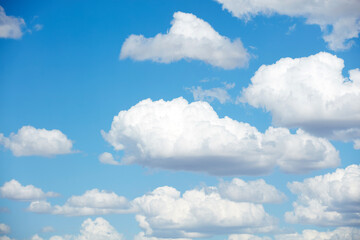 Blue skies with summer cumulus clouds.