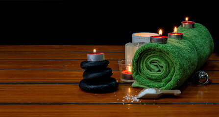 Concept of spa with massage stone, towel and candles