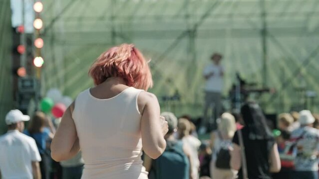 Woman dancing during concert in daytime