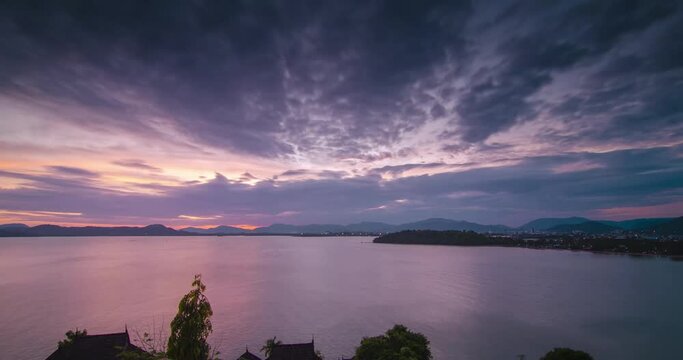 4K Time lapse of sunset over tropical sea ocean landscape light of nature cloudscape sky and Clouds moving .Nature environment background