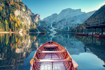 Boats on the Braies Lake ( Pragser Wildsee ) in Dolomites mountains, Sudtirol, Italy. Alps nature landscape. - 526998274