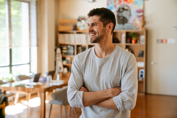 Fototapeta premium White bristle man smiling and looking aside while working at office