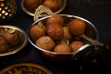 Indian Gulab Jamun in a festive setting , black backround, copy space